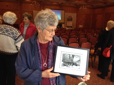 Lois Rigney shows her "Frank Thom" framed photo door prize!