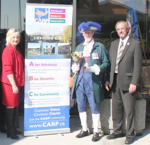 National Seniors Day Oct. 1 was marked with a flag raising at the Chatham-Kent Civic Centre. From left are CARP Chapter 49 chair Susan Bechard, Town Crier George Sims and Mayor Randy Hope.