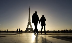 Tourists walk by the Effel Tower